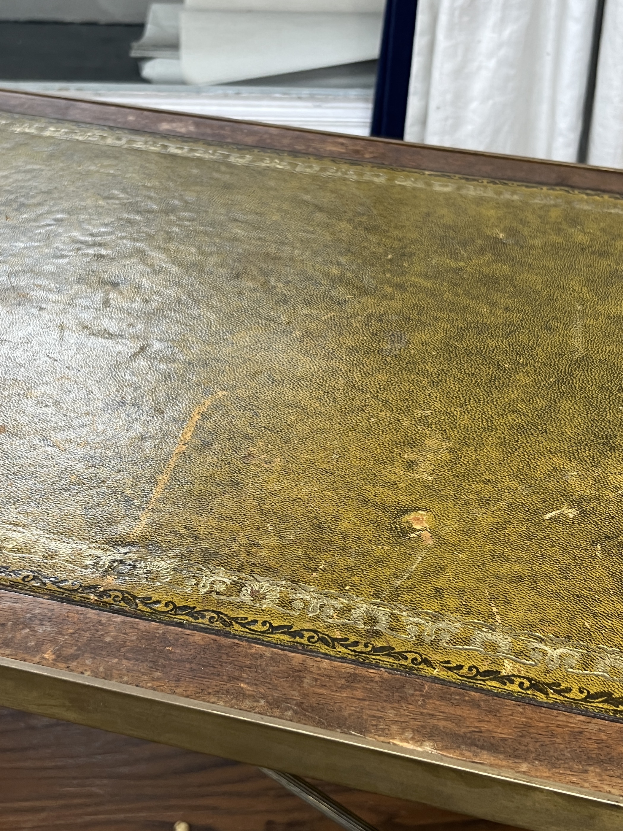 A mid century rectangular brass and mahogany leather topped coffee table with lion paw feet, width 107cm, depth 44cm, height 38cm